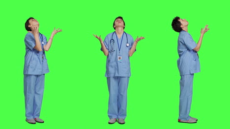 Hospital-nurse-worshipping-God-by-prayer-against-greenscreen-backdrop